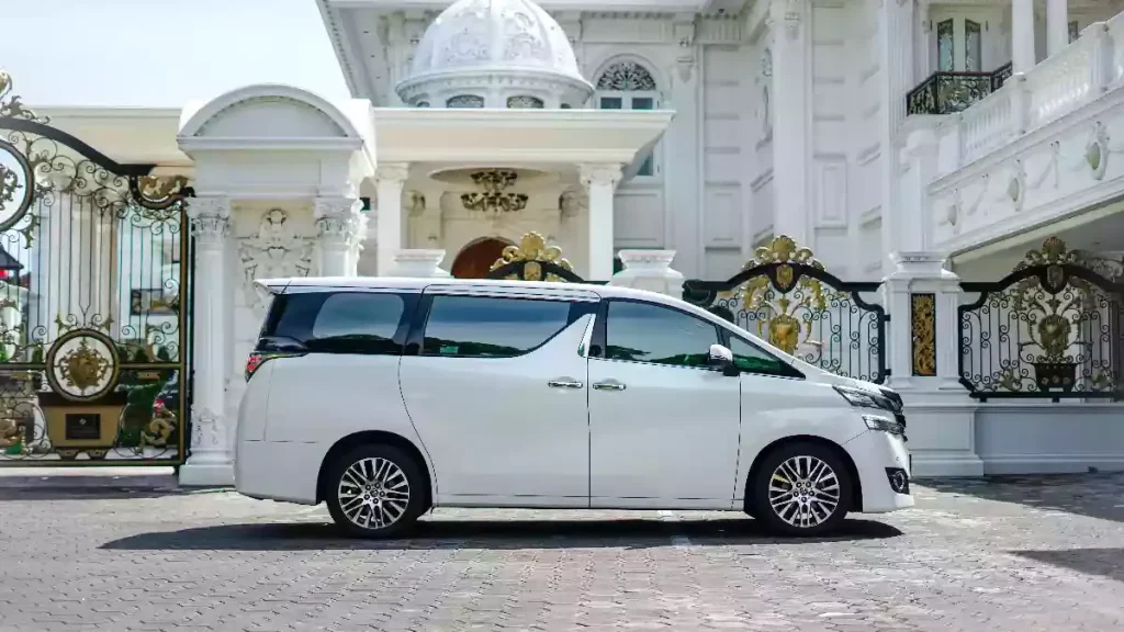 White Toyota Vellfire parked at a gate