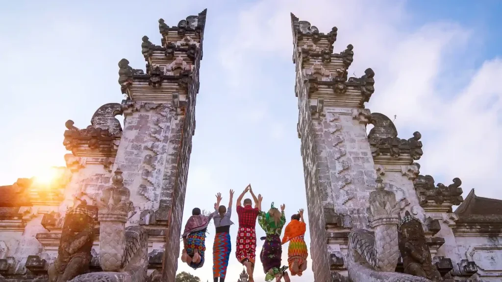 Visitors at the Lempuyang temple gates in Bali, seen from behind